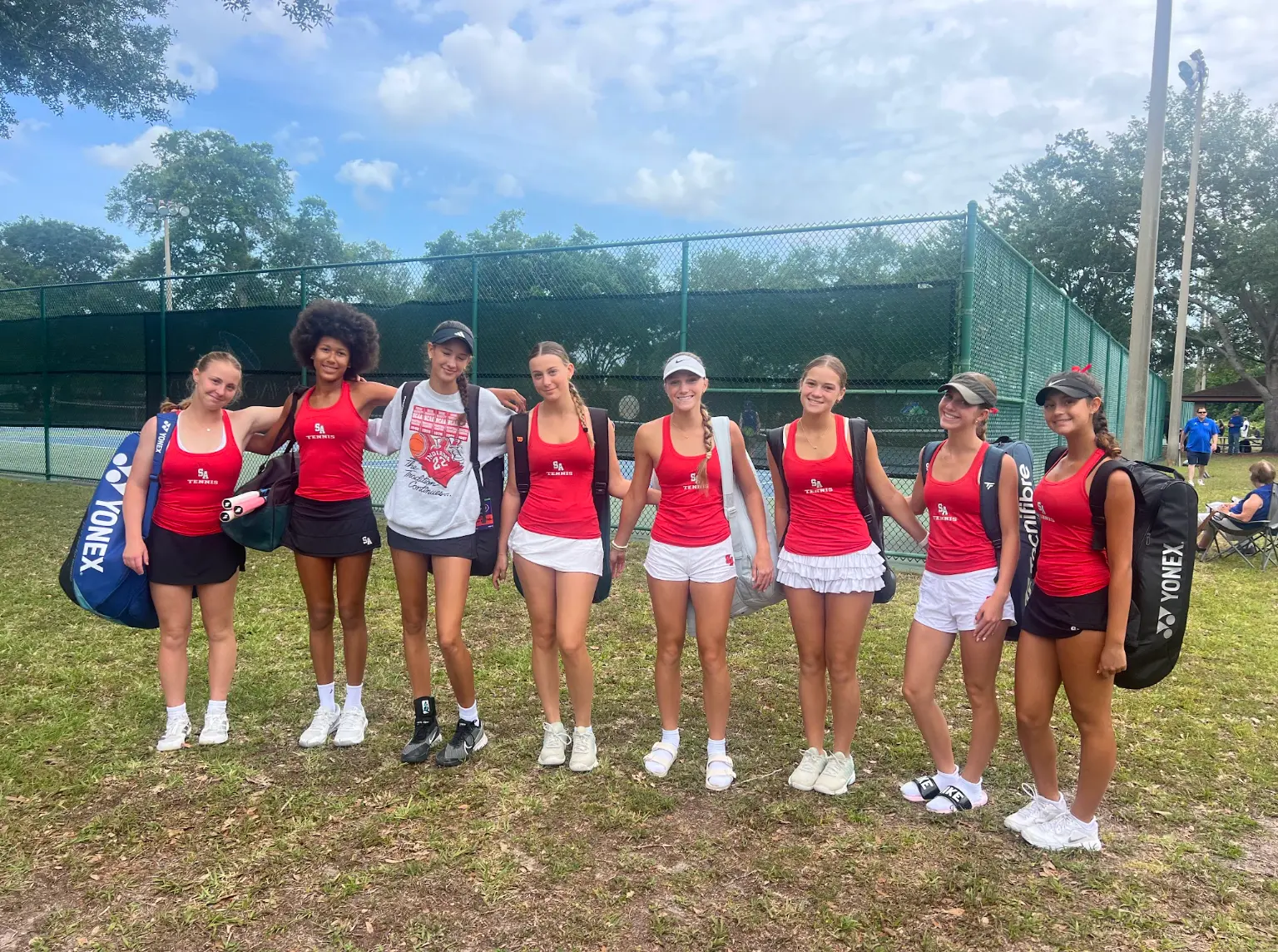 Saint Andrew's tennis team together at a tournament